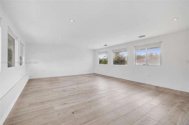 empty room with light hardwood / wood-style flooring