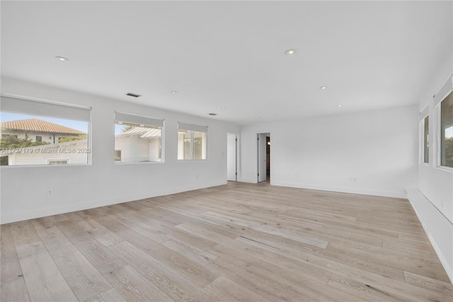 spare room featuring light wood-type flooring