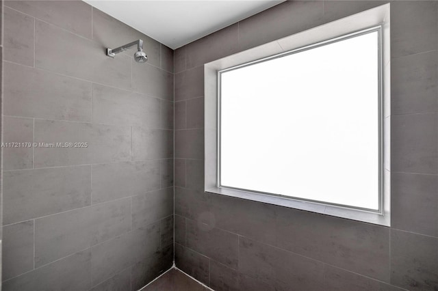 bathroom with a tile shower