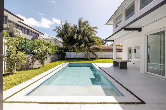 view of swimming pool featuring a patio and a fire pit