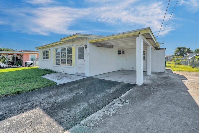 exterior space featuring a carport and a front yard