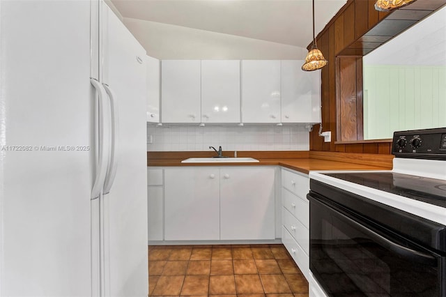 kitchen featuring pendant lighting, white appliances, white cabinets, sink, and vaulted ceiling