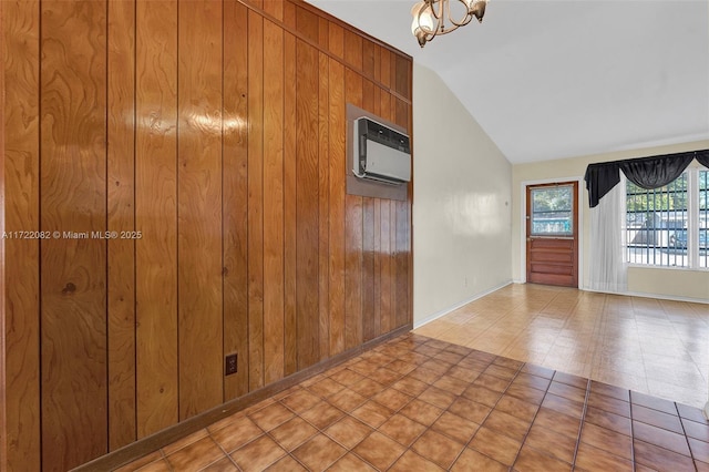 interior space featuring an inviting chandelier, vaulted ceiling, wooden walls, and a wall unit AC