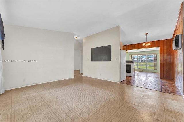 unfurnished living room with a wall mounted air conditioner and wood walls