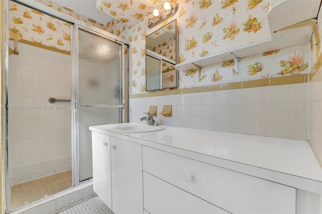 bathroom with tile patterned flooring, vanity, and an enclosed shower