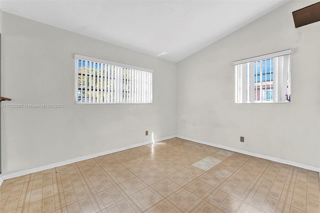 empty room featuring lofted ceiling