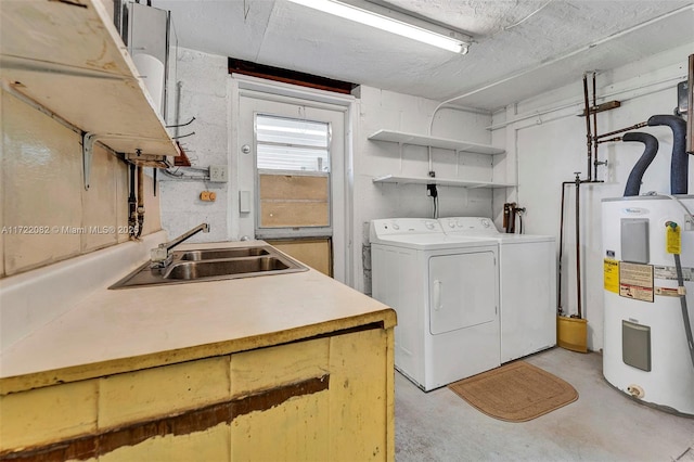 laundry area with washing machine and clothes dryer, electric water heater, and sink