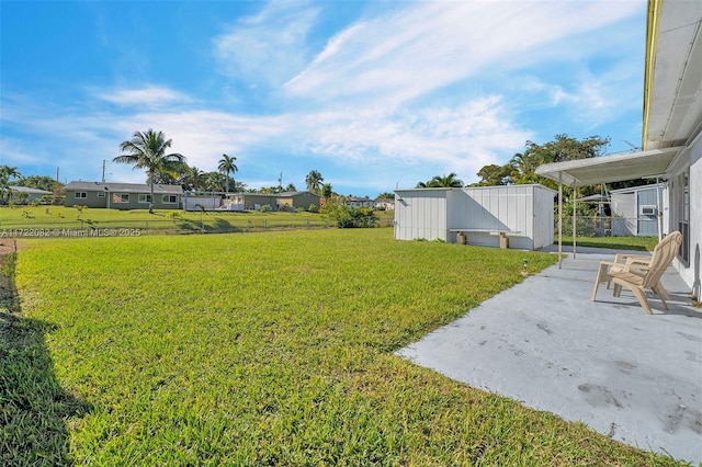 view of yard with a patio and a storage unit