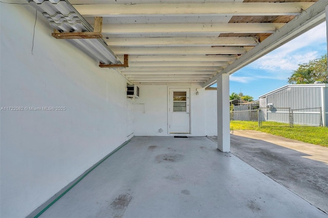 view of patio with a wall unit AC