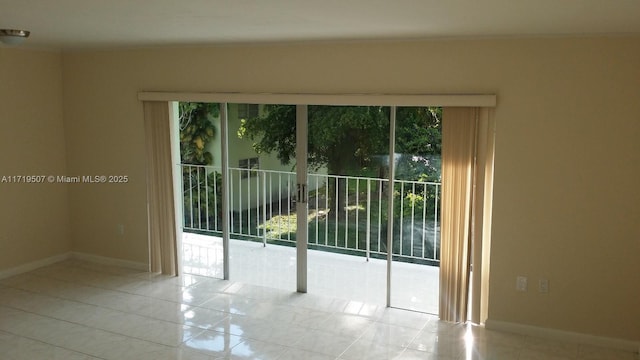 tiled spare room featuring plenty of natural light