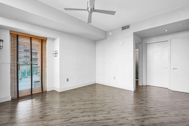 empty room featuring ceiling fan and dark hardwood / wood-style floors