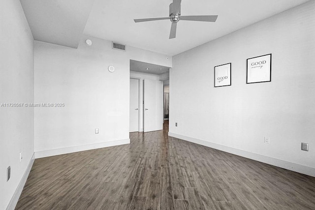 spare room with ceiling fan and dark wood-type flooring