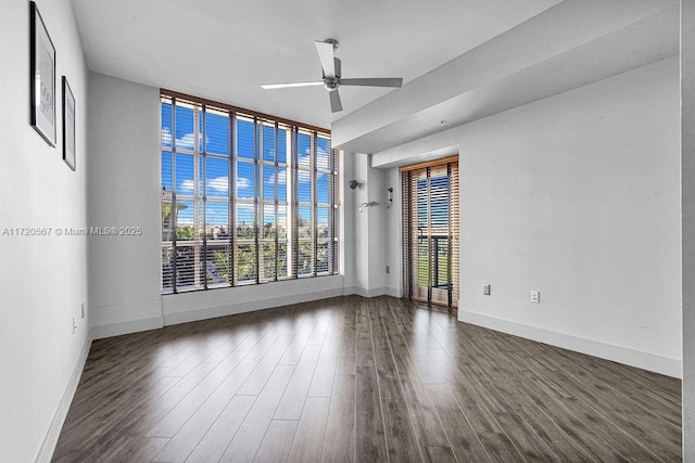 unfurnished room with ceiling fan and dark hardwood / wood-style flooring