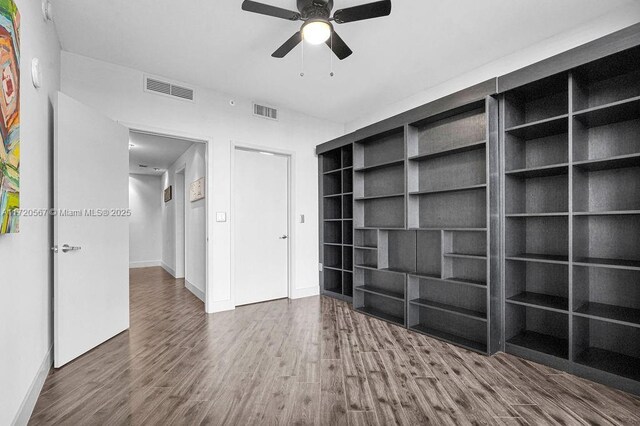 unfurnished room featuring ceiling fan and dark hardwood / wood-style floors