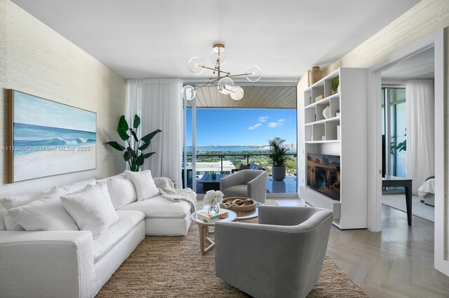 living room with parquet flooring and a notable chandelier