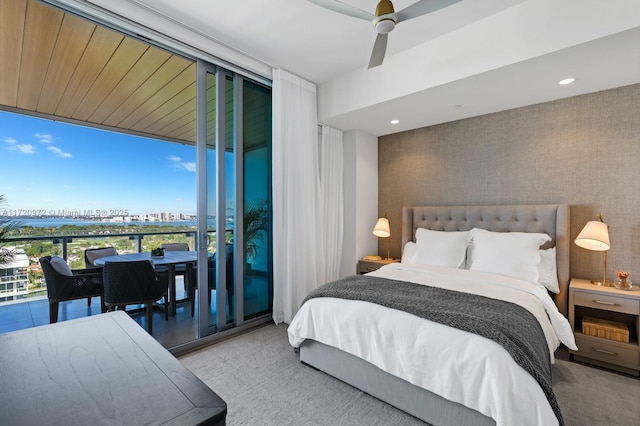 carpeted bedroom featuring floor to ceiling windows and ceiling fan