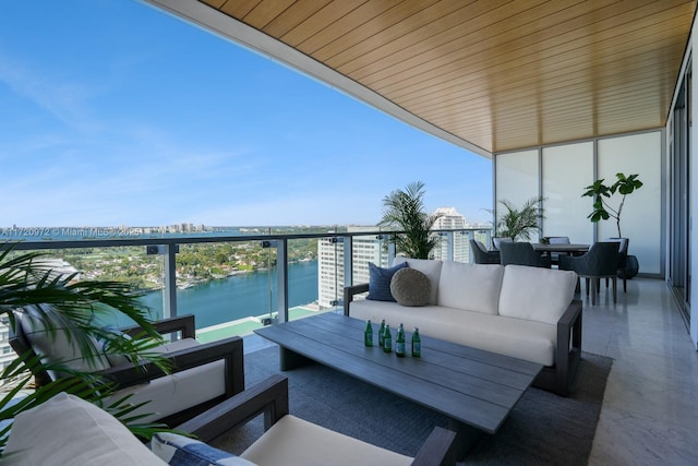 balcony featuring a water view and an outdoor hangout area