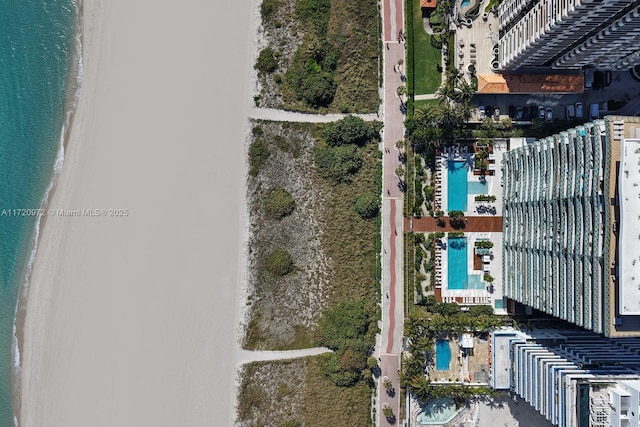 bird's eye view with a view of the beach and a water view