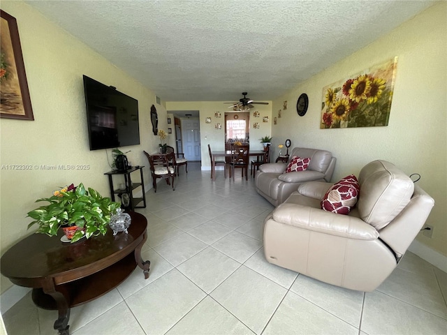 tiled living room featuring ceiling fan and a textured ceiling