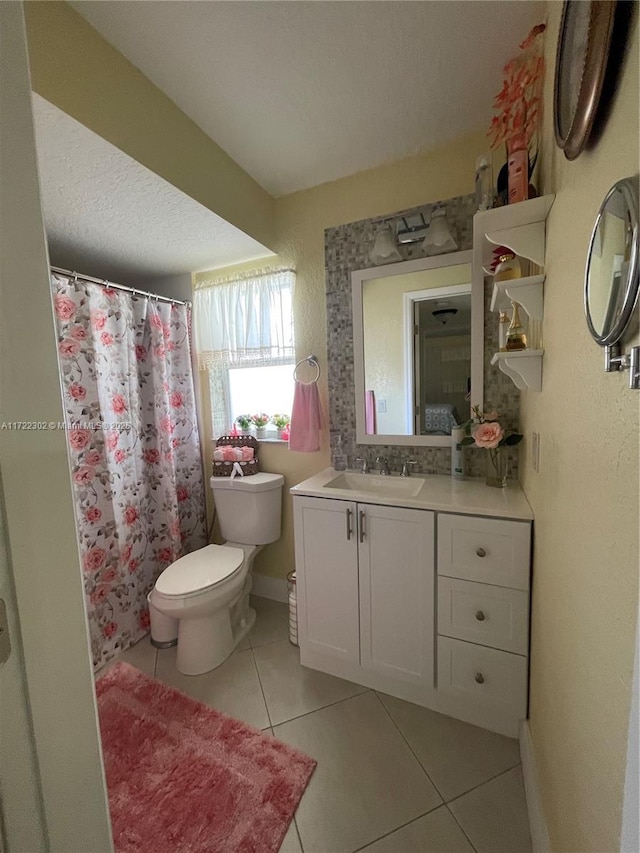 bathroom featuring tile patterned floors, vanity, and toilet