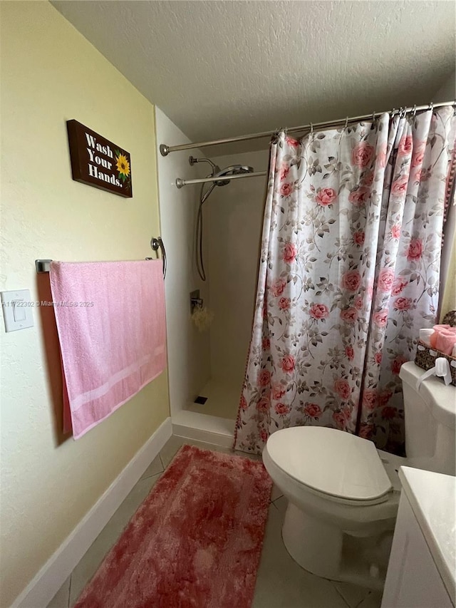 bathroom featuring walk in shower, vanity, a textured ceiling, tile patterned flooring, and toilet