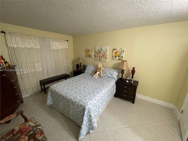 tiled bedroom featuring a textured ceiling