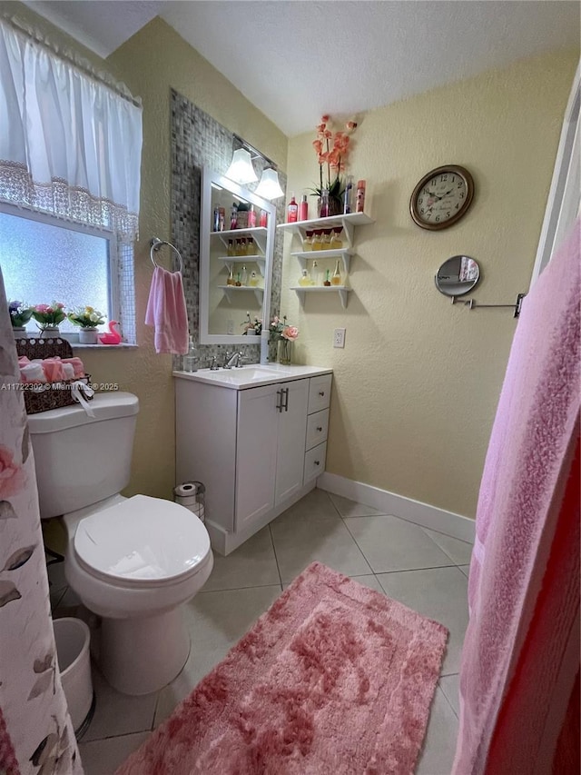 bathroom featuring tile patterned flooring, vanity, and toilet