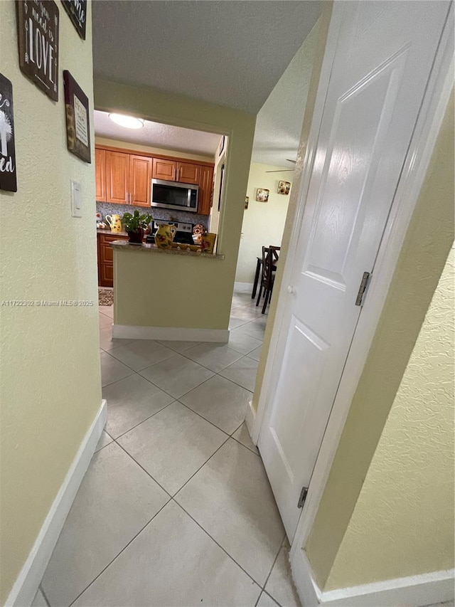 hallway featuring light tile patterned floors