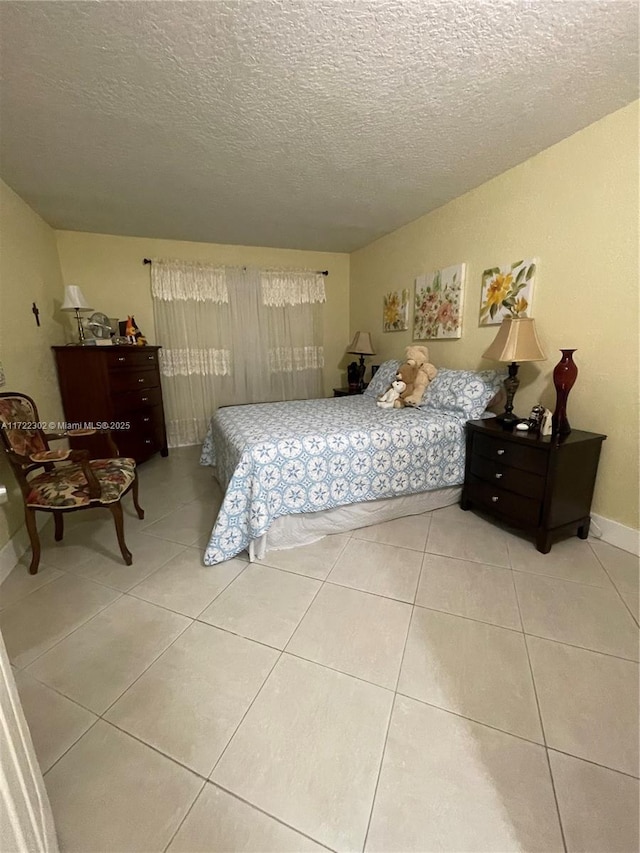 tiled bedroom with a textured ceiling