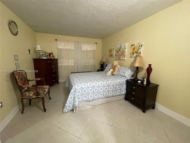 tiled bedroom featuring a textured ceiling