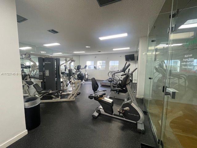 workout area with a textured ceiling