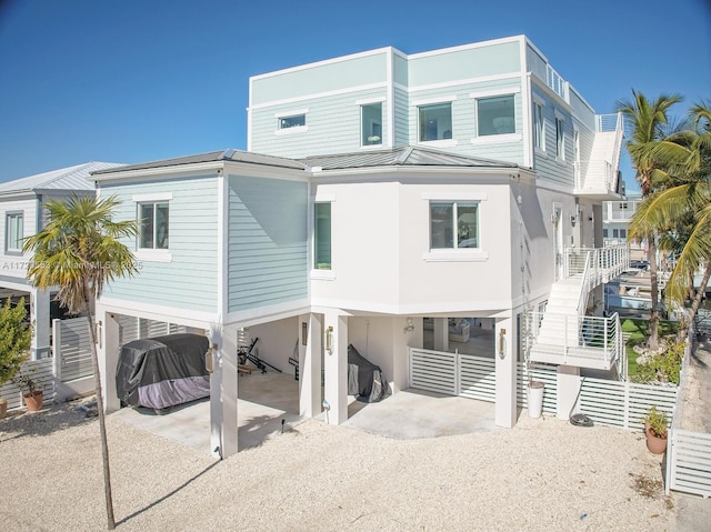 rear view of house featuring a carport