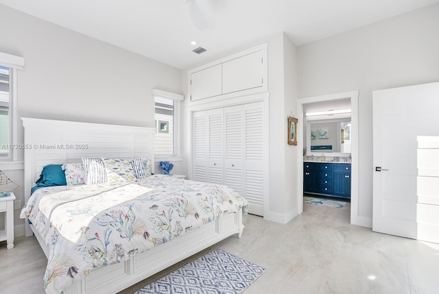 bedroom featuring ceiling fan, a closet, and ensuite bathroom