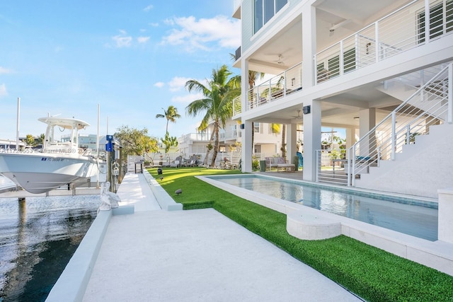 view of pool featuring a boat dock and a patio area