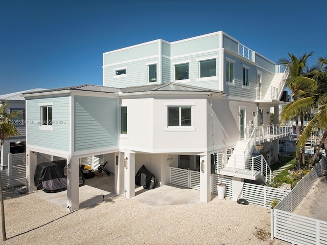 back of property featuring a carport