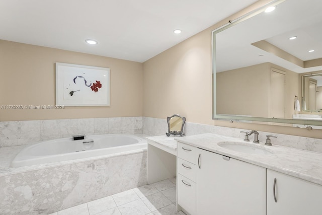 bathroom with vanity, tile patterned floors, and tiled tub