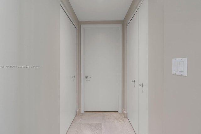 hallway featuring light tile patterned floors