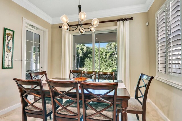 tiled dining space featuring an inviting chandelier and ornamental molding