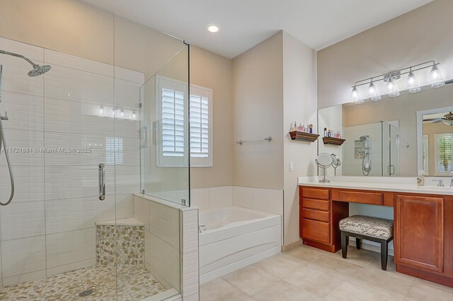 bathroom featuring tile patterned flooring, ceiling fan, vanity, and independent shower and bath