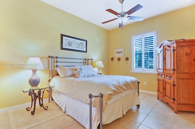 bedroom with a ceiling fan, light tile patterned flooring, and baseboards