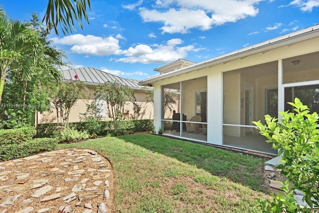 view of yard featuring a sunroom