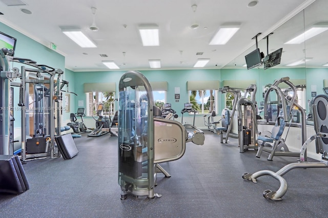 exercise room featuring crown molding