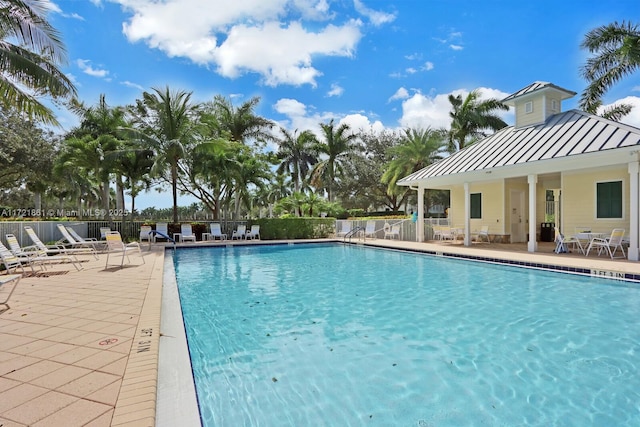 community pool featuring a patio area and fence