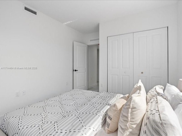 bedroom featuring visible vents and a closet