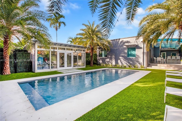 view of pool with a lawn and a patio area