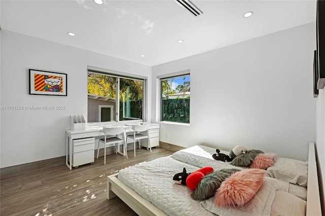 bedroom with dark wood-type flooring