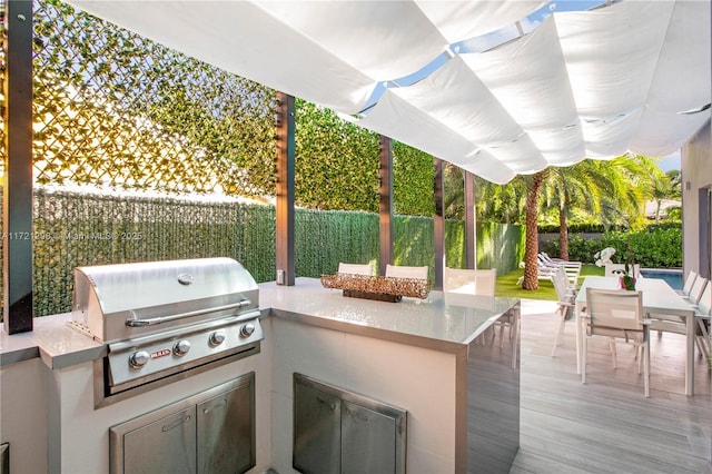 view of patio featuring area for grilling and a deck