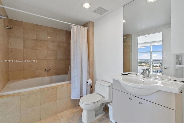 full bathroom featuring tile patterned floors, vanity, shower / bath combo, and toilet