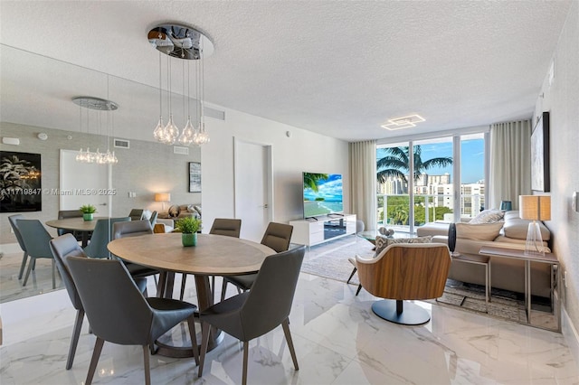 dining area featuring expansive windows, a chandelier, and a textured ceiling