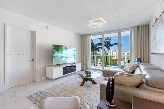 living room featuring expansive windows and a textured ceiling